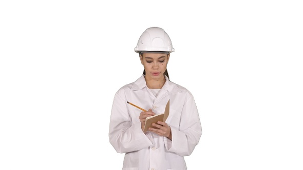 Woman engineer writing checklist walking on white background. alt