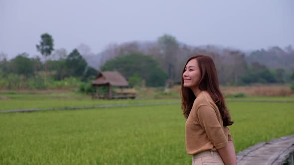 Slow motion of a woman looking at a paddy field