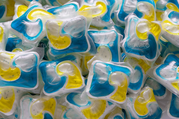 Dishwasher detergent and or laundry soap capsules, close up background.