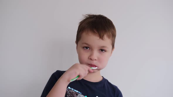 Little Boy Brushing Teeth with Toothbrush and Toothpaste