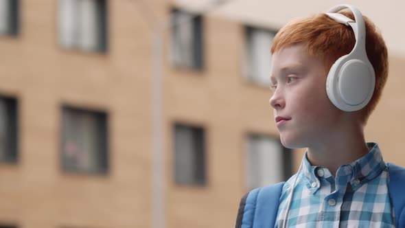 Ginger Boy Listening to Music via Headphones alt