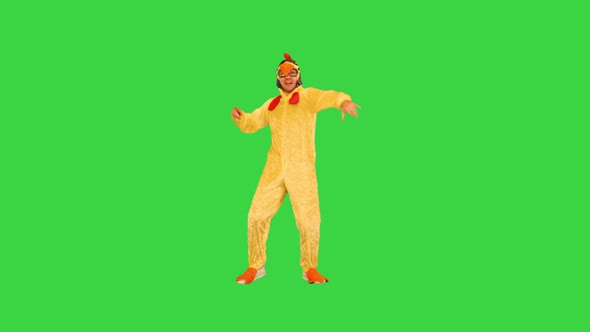 Active Guy in Chicken Costume Tries to Entertain Audience on a Green Screen Chroma Key