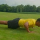 Motivated Sporty Fit African Man Doing Advanced Push Up Exercise in Nature - VideoHive Item for Sale