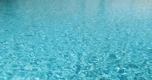 Blue Clear Water in Hotel Pool on Sunny Day alt