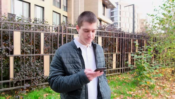a man using a touch-sensitive mobile phone on the street. 4k