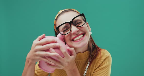 Happy woman kissing a money box