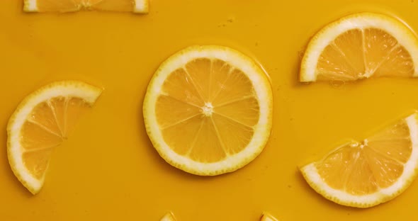 Top view rotation of fresh slice of lemons juice and gel serum
