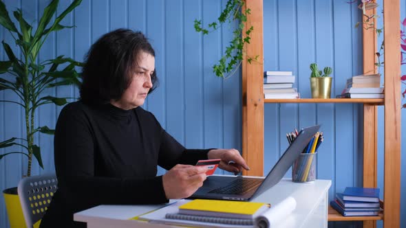 Old Woman Online Shoping at Home Typing Credit Card Number and Cancel the Purchase alt