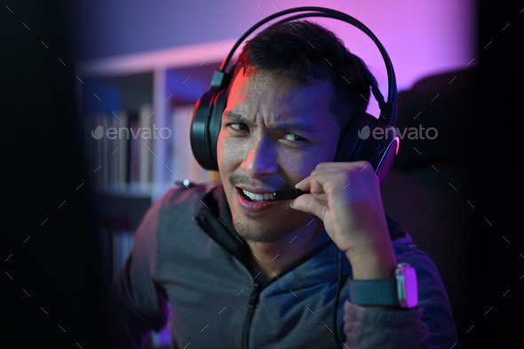 Asian male gamer playing online video game on pc. Stock Photo by ...