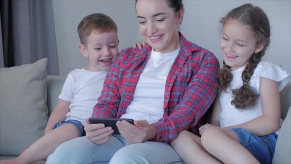 Happy Family,mom and Cute Little Children Watch the Phone,mom Plays with Children at Home,relaxing alt