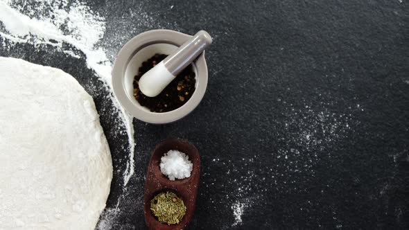 Pizza dough and flour with ingredient alt