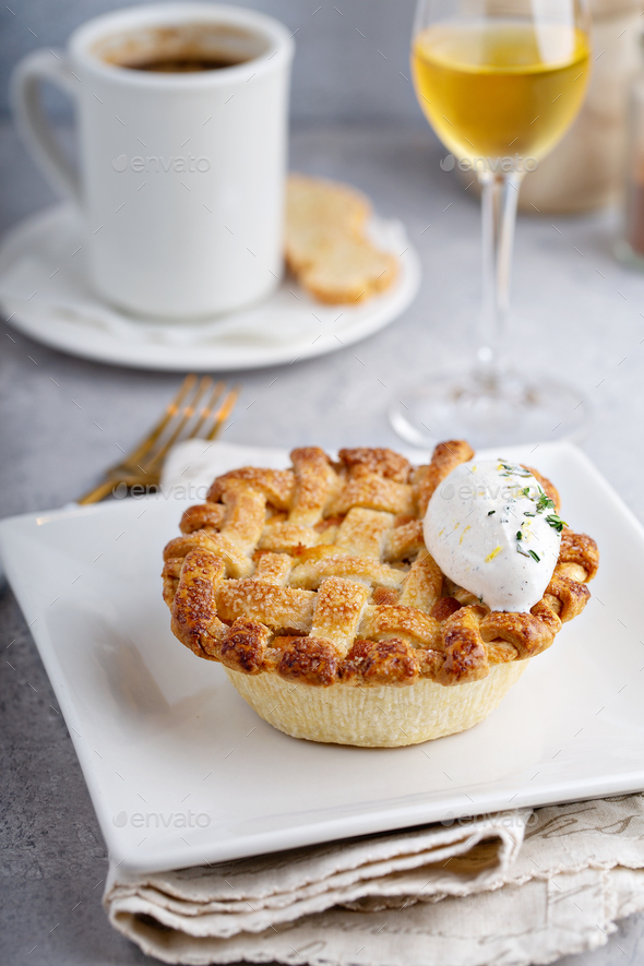Peach pie topped with lattice and whipped cream