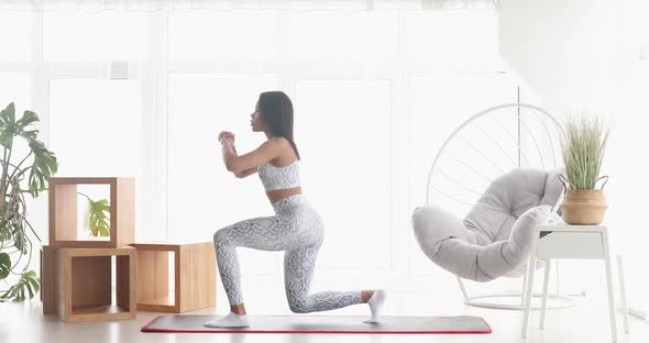 Athletic fit girl doing fitness aerobic exercises for booty in living room. alt