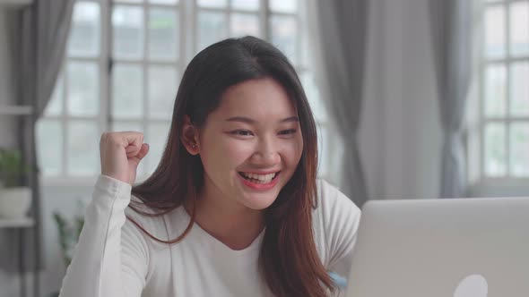Girl Use Laptop Computer And Celebrating At Desk alt