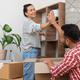 young couple , give high five unpacking and arranging furnitures, marking their relocation - PhotoDune Item for Sale