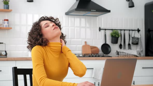 Tired Businesswoman Massaging Neck Stretching After Long Hard Work at Laptop alt