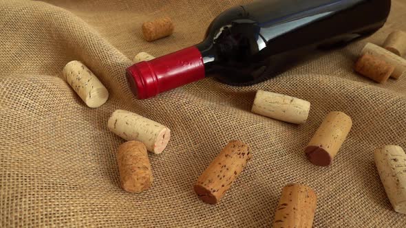 Wine in bottles and falling corks on the bag. Slow motion alt