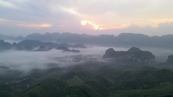 Aerial view and fly over sea of fog with sunrise cover mountain in area of Doi Ta pang Thailand