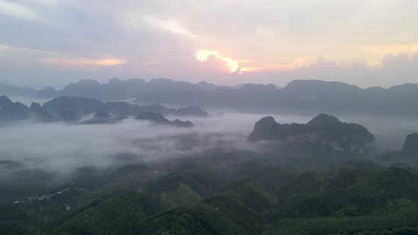Aerial view and fly over sea of fog with sunrise cover mountain in area of Doi Ta pang Thailand