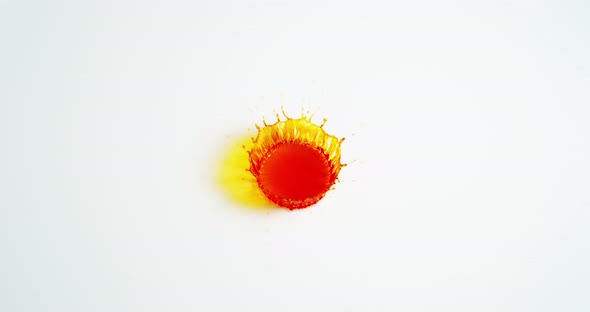 Orange Liquid falling into Water against White Background, Slow motion 4K alt