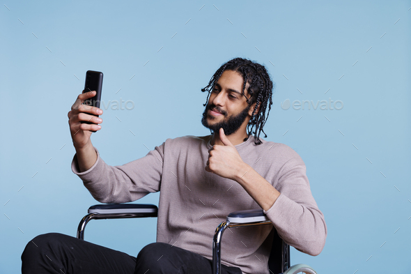 Middle eastern man does thumbs up Stock Photo by DC_Studio