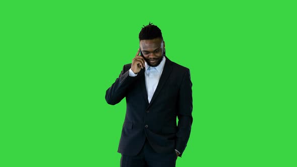 Black Man in Office Suit Talking on Mobile Phone on a Green Screen Chroma Key