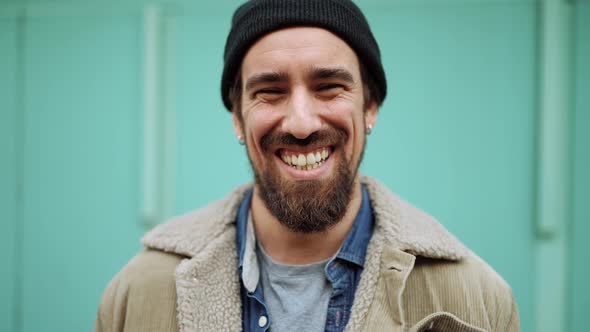 Funny bearded man wearing hat looking at the camera alt