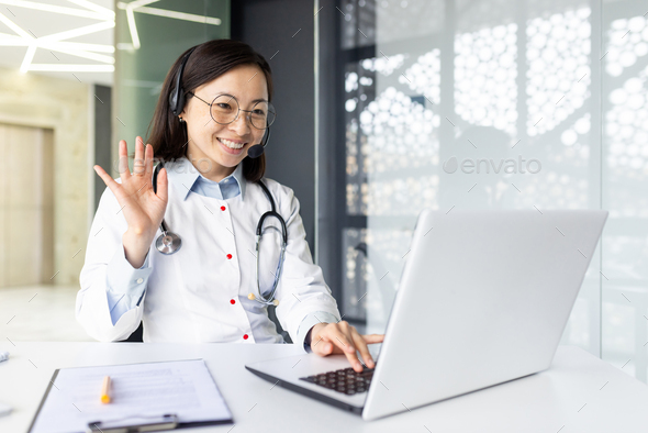 Asian female doctor providing remote consultation online in clinic office space