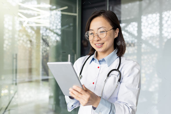 Professional asian female doctor consulting patients remotely with digital tablet