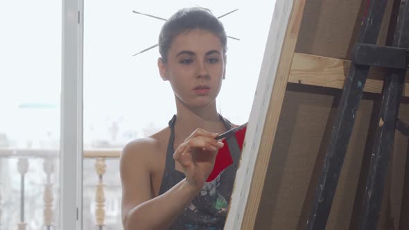 Elegant Woman Painting a Picture at the Workshop alt