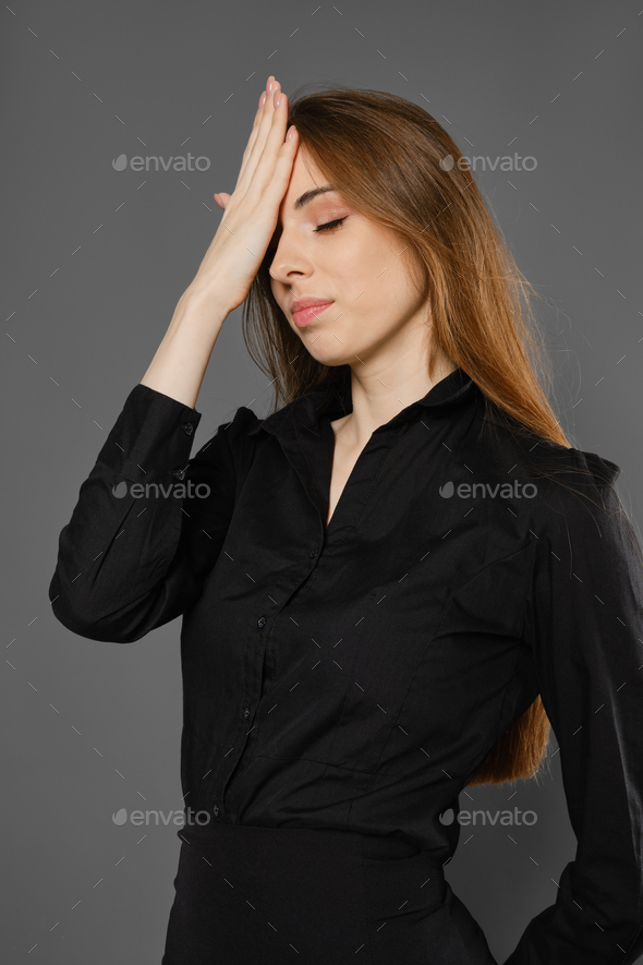 Upset woman makes facepalm gesture - Stock Photo - Images