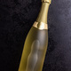 Bottle of champagne on black table. Top view. - PhotoDune Item for Sale