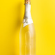 Bottle of champagne on yellow background. Top view. - PhotoDune Item for Sale