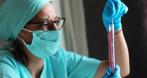 Doctor holding a coronavirus COVID-19 test tube