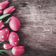 Red easter eggs and pink tulip flower on vintage wooden table from above.  - PhotoDune Item for Sale