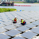 Wide shot of professional technician workers sit and work with solar cell panel also use laptop - PhotoDune Item for Sale