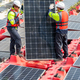 Vertical image of two professional technician workers stand and hold solar cell panel to check - PhotoDune Item for Sale