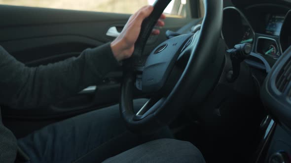 Man is Driving a Car Closeup alt