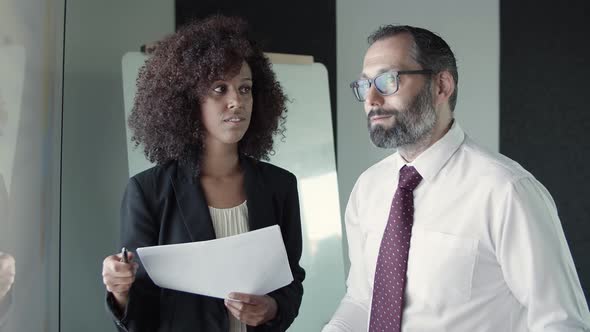 African American Businesswoman Holding Pen and Talking with CEO alt
