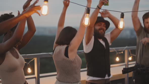 Group of Friends Dancing on Rooftop alt