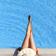 Top view of lady in swimsuit and hat in luxury hotel resort poolside.  - PhotoDune Item for Sale