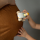 Little girls hand drives a toy on mom baby tummy - PhotoDune Item for Sale