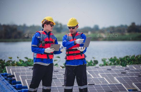 Software engineers upgrade energy app. Using real-time monitoring on floating solar farming. - Stock Photo - Images