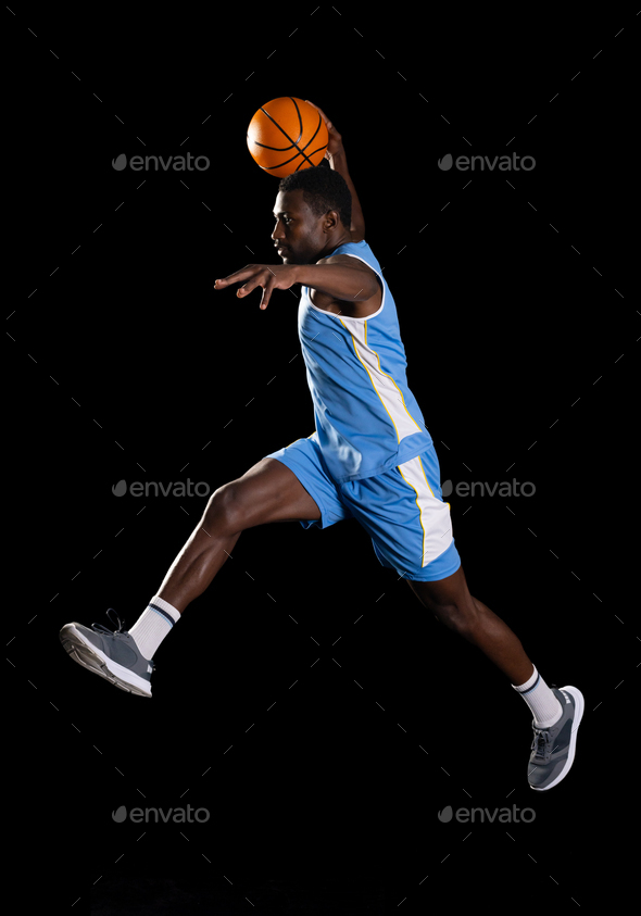 African American man in mid-air basketball action