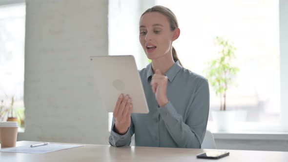 Online Video Chat on Tablet By Woman in Office alt