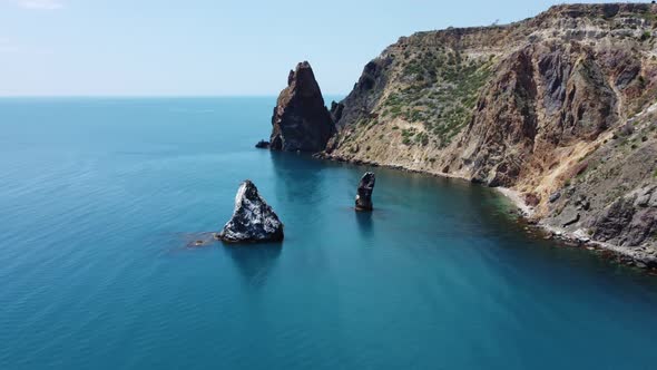 Aerial View From Above on Azure Sea and Volcanic Rocky Shores alt