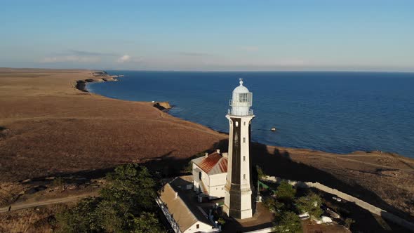 Aerial View of the Coastal Maritime Lighthouse Stands on the Seashore or Ocean alt