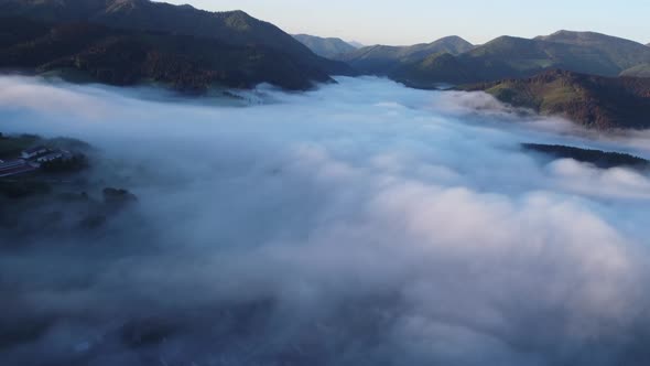 Aerial View From Above of a Foggy Landscape in the Light of the Morning Sun