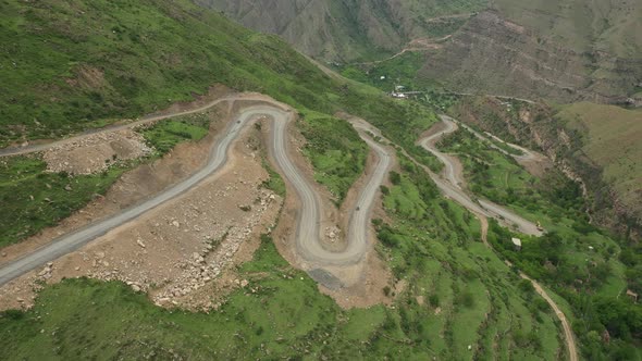 Tiny Cars Driving Along Serpentine Mountain Road in Dagestan