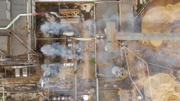 Aerial View of Wood Processing Plant with Smokestack From Production Process Polluting Environment alt